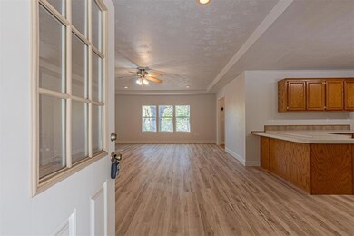 Kitchen with a textured ceiling, a raised ceiling,