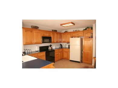 L Shaped kitchen with tile floor