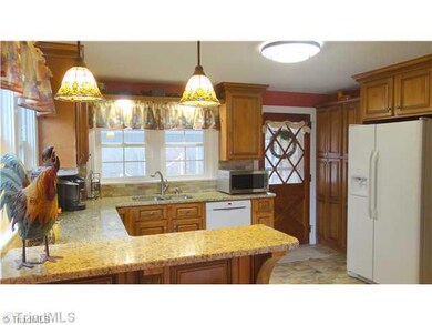 Kitchen. Completely remodeled kitchen.  Granite countertops, tile splash, new cabinets ,tile floors, eat at bar.
