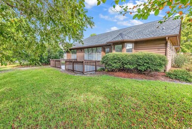 Back of property with a yard and a deck
