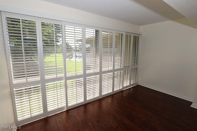 Spare room with dark hardwood / wood-style flooring