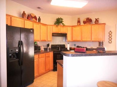 Nice open kitchen with pretty cabinets, cool count