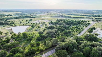 Aerial view of property and surrounding area with a large body of water