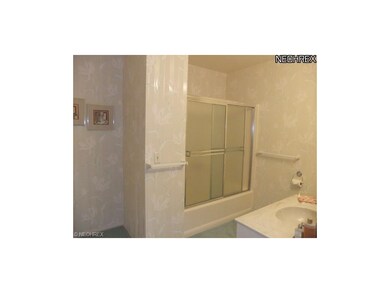 The guest bathroom shows off tub/shower surround, 
