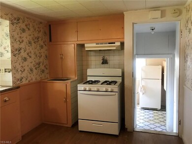 Kitchen off mudroom. Stove and extra refrigerator 