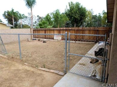 Large dog run / kennel area next to the house.