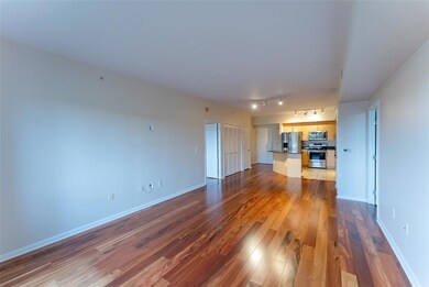 Unfurnished living room featuring wood finished f