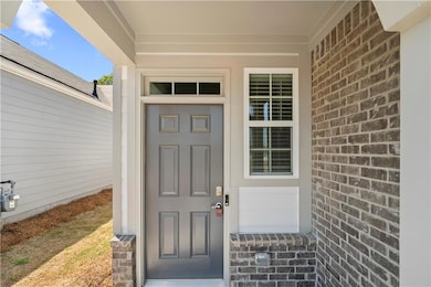 Doorway to property featuring brick siding