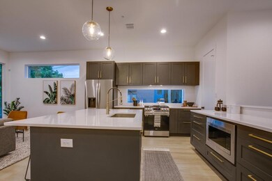 Kitchen featuring decorative light fixtures, sink,