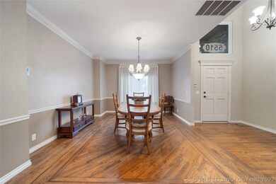 Formal dining room with custom hardwood floors.