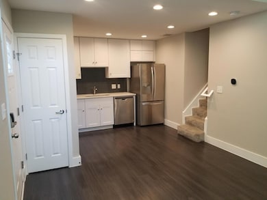 Kitchen featuring dark wood finished floors, whit