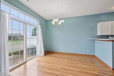 The dining area has a sliding door with a transom that leads out to the patio.