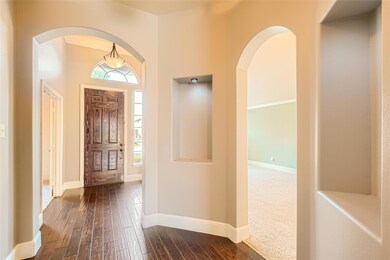 Carpeted entryway featuring ornamental molding