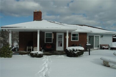 The side covered porch leads to the kitchen for ea