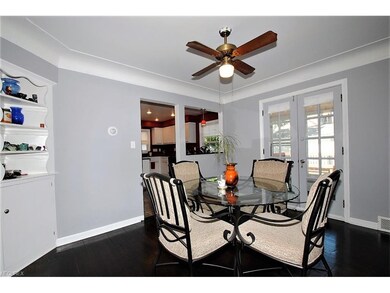 FRENCH DOORS IN DINING ROOM LEAD TO ENCLOSED PORCH