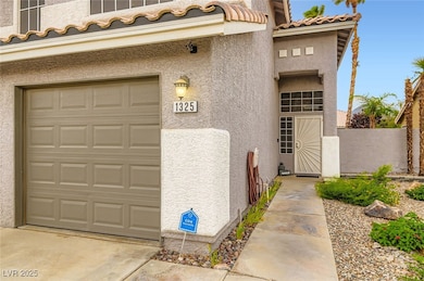 View of exterior entry with stucco siding, a tiled