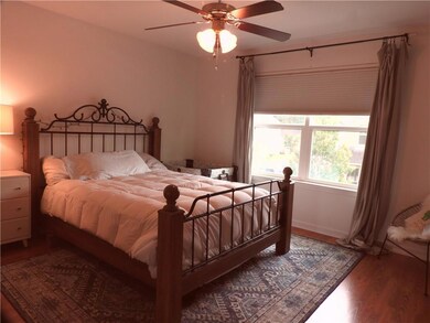 Upstairs Primary Bedroom with Front View and Attached Bath and Walk-In Closet