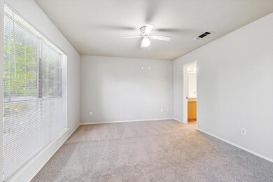 Spare room with light carpet and ceiling fan