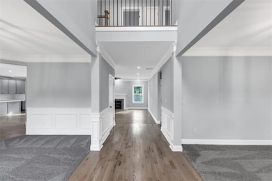Foyer featuring wood finished floors, wainscoting,