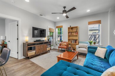 Living room with wood finished floors, ceiling fa
