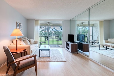 Living room with ceiling fan, floor to ceiling win