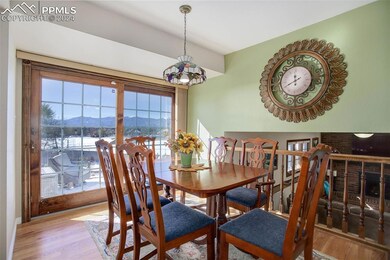 Dining room with a mountain view and light hardwoo