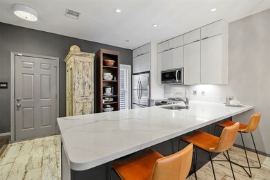 The updated kitchen features quartz coutertops wit