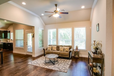 Living area with vaulted ceiling, ceiling fan, ba