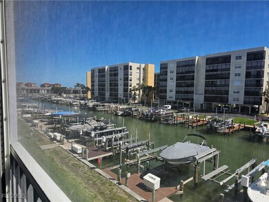 Dock featuring boat lift, view of marina, and a water view