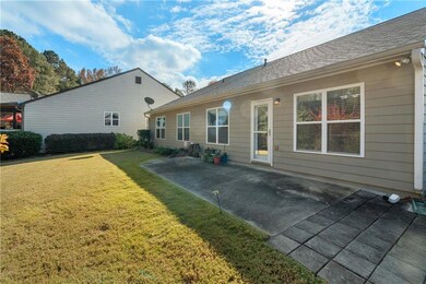 Back of property featuring a lawn, a patio, and roof with shingles