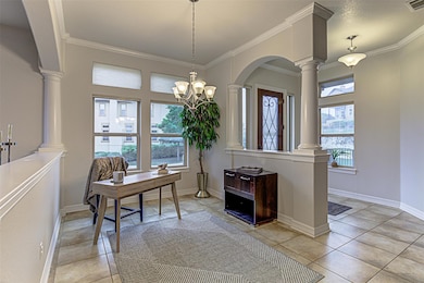 Home office featuring ornamental molding, baseboa