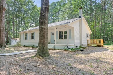 Single story home featuring a deck and a storage u
