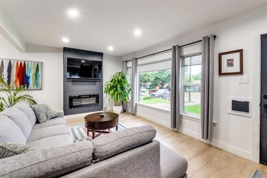 Living room with light hardwood / wood-style floor