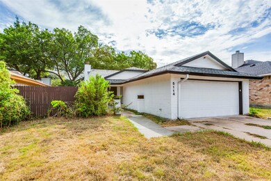 View of front of house with a garage and a front lawn