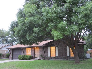 This home is graced with a big shady majestic tree
