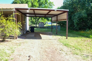 View of car parking featuring a carport
