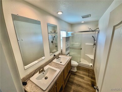 Full bathroom with visible vents, a stall shower,