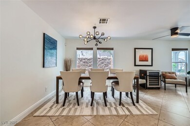 Dining space featuring a chandelier, light tile pa