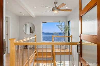 Upon entering the foyer, you are welcomed by a fresh interior of crisp white walls and natural wood finishes directly flowing into the Pacific Northwest scenery in all its splendor and the Big Blue.