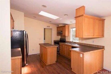 Kitchen with small island. Recessed lighting. Ligh
