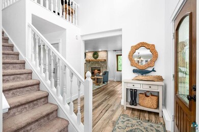 Entrance foyer with brick wall, wood-type flooring