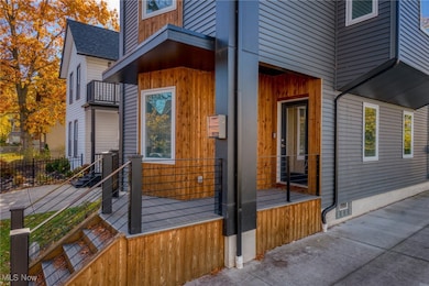 View of side of property featuring roof with shingles