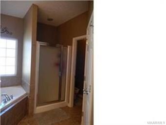 Master bath has separate shower and garden tub.