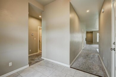Hallway with light colored carpet