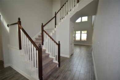 Staircase with wood finished floors and baseboards