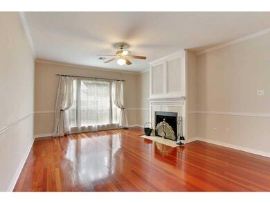 Photo. Den with wood burning fireplace, wood floor