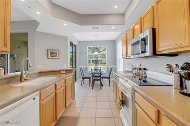 Kitchen with white appliances, light tile patterne
