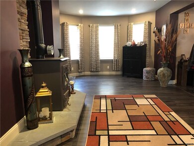 Living Room featuring alcove with 3 large windows.