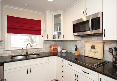 Decorative glass cabinet, built-in microwave and glass cooktop.