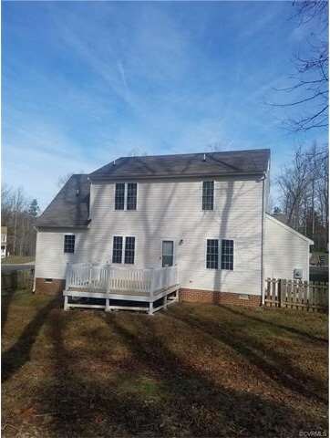 Rear of house in fenced in rear yard